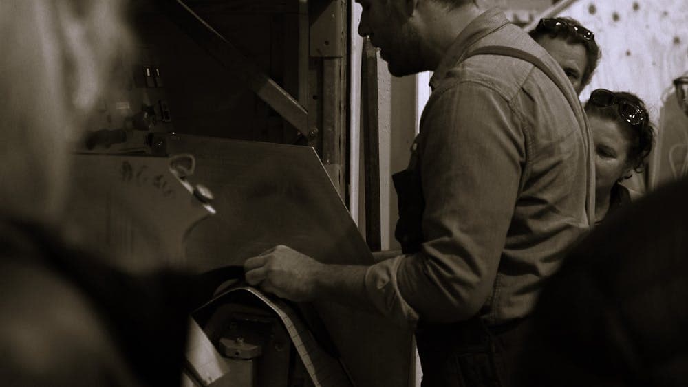 Bootmaker demonstrating the blocking process for boots