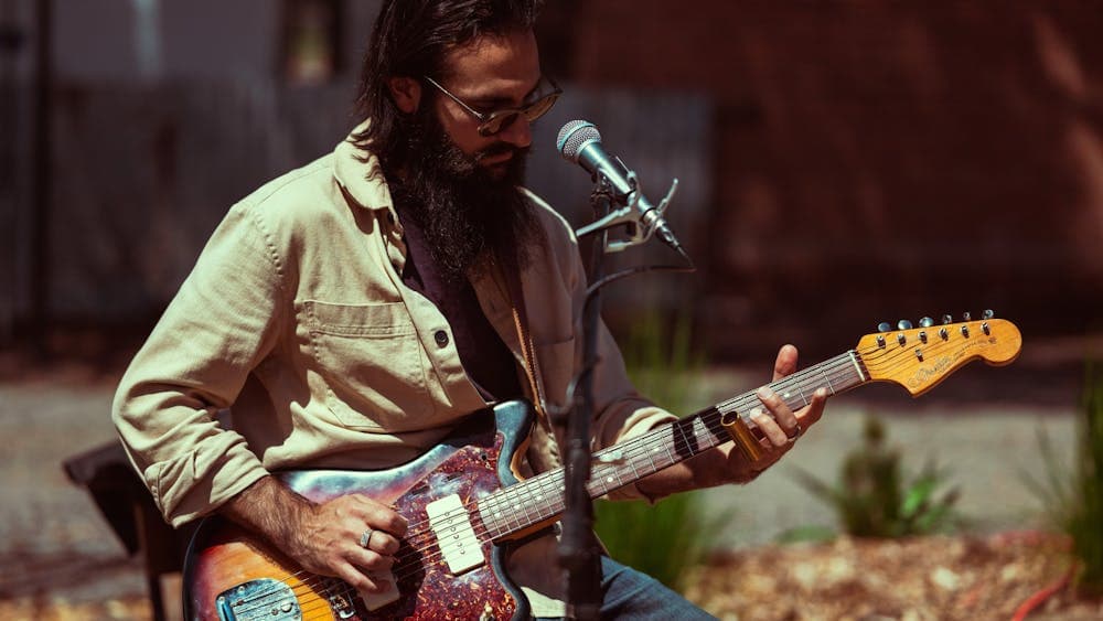 Image of male playing guitar