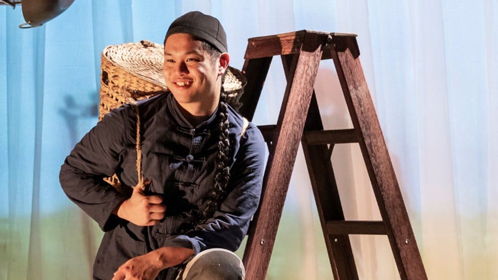 Yong smiling on a ladder