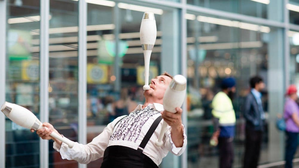 The Great Dave juggling three bowling pins