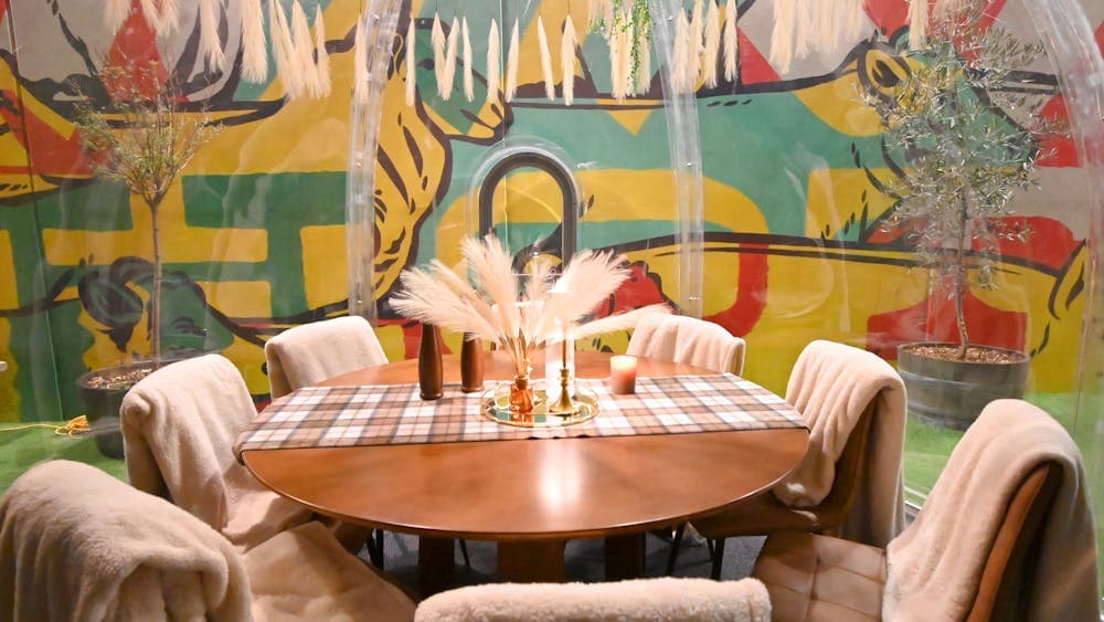 Cosy winter igloo with dining chairs and table and throw rugs