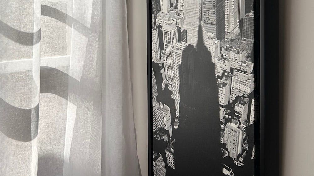 A partial view of a panoramic image taken in New York. A building shadow overlaps a large cityscape