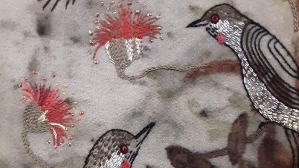 Embroidered black and white birds and red flowers