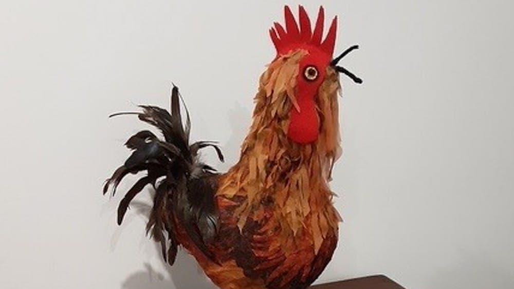 A rooster made from various materials