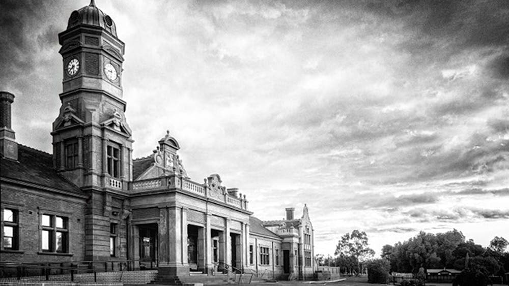 Black and white photograph of building with a clock tower