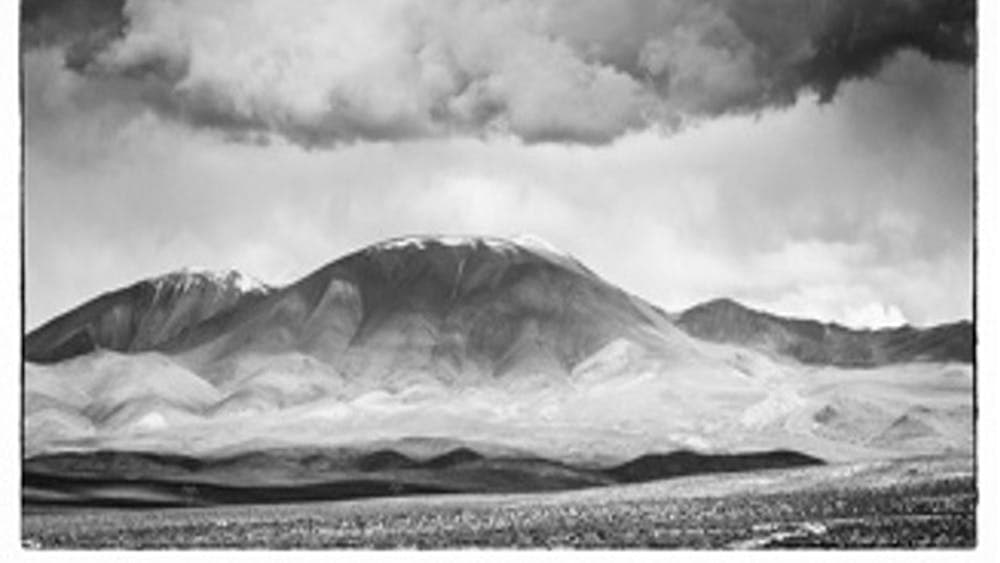 Black and white photograph of a landscape involving mountains