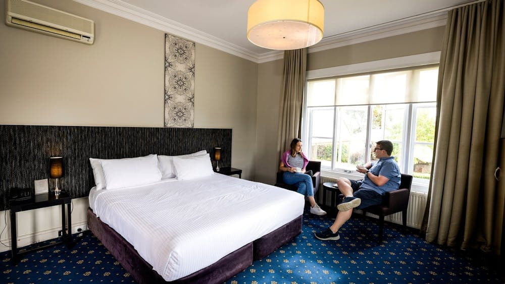 Man and woman seated inside a room