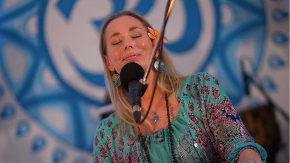Woman smiling while playing harmonium