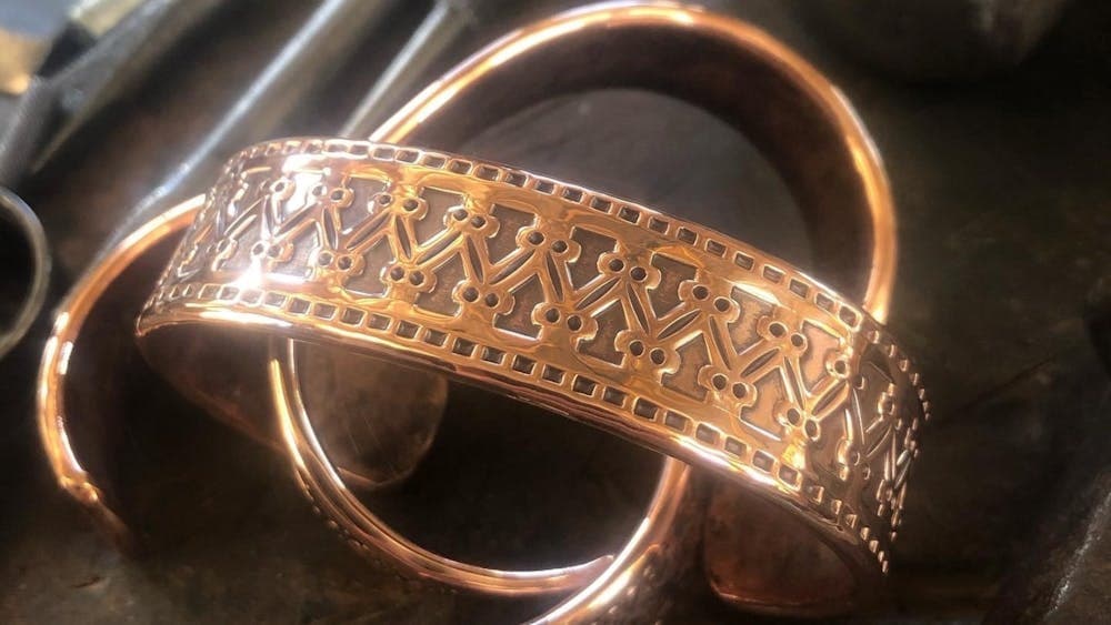 Brass cuffs with intricate Norse inspired designs