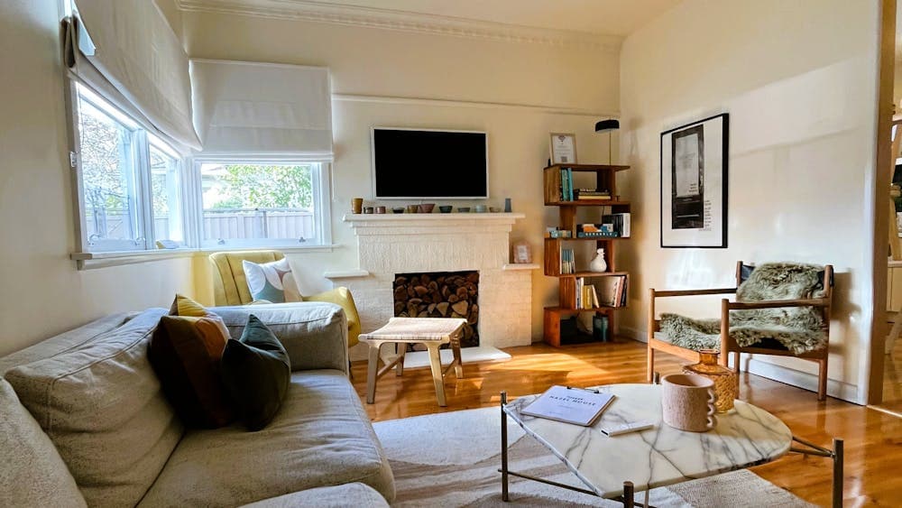 Loungeroom, tv, couches, chairs , coffee table and books.