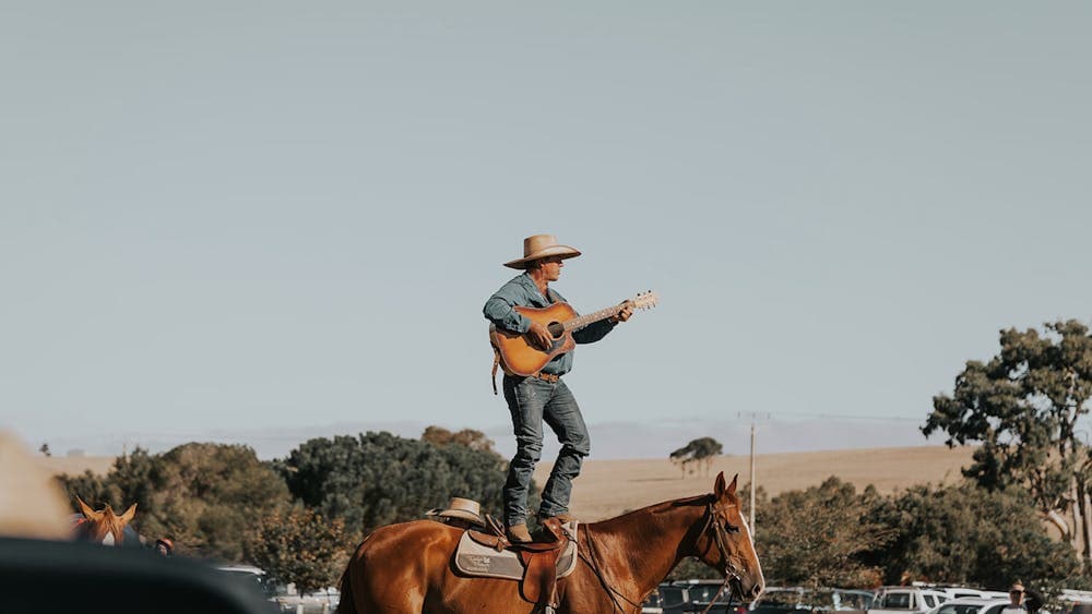 Tom singing on a horse