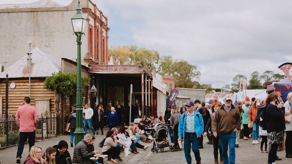 Main Street of Clunes filled with people and stalls for the Clunes Booktown Festival