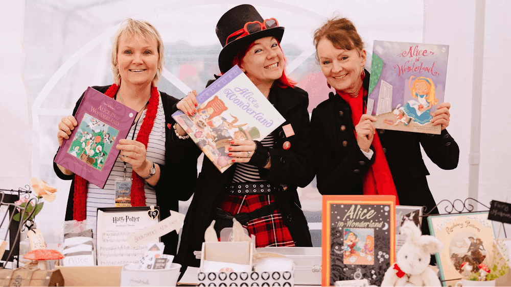 Three Booksellers smiling at the camera