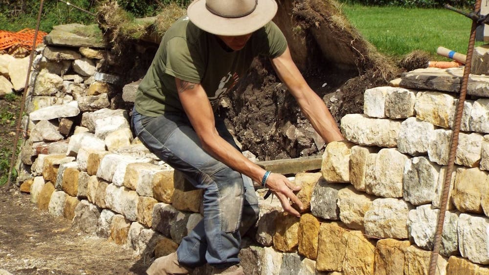 Emma Knowles adding stone to wall
