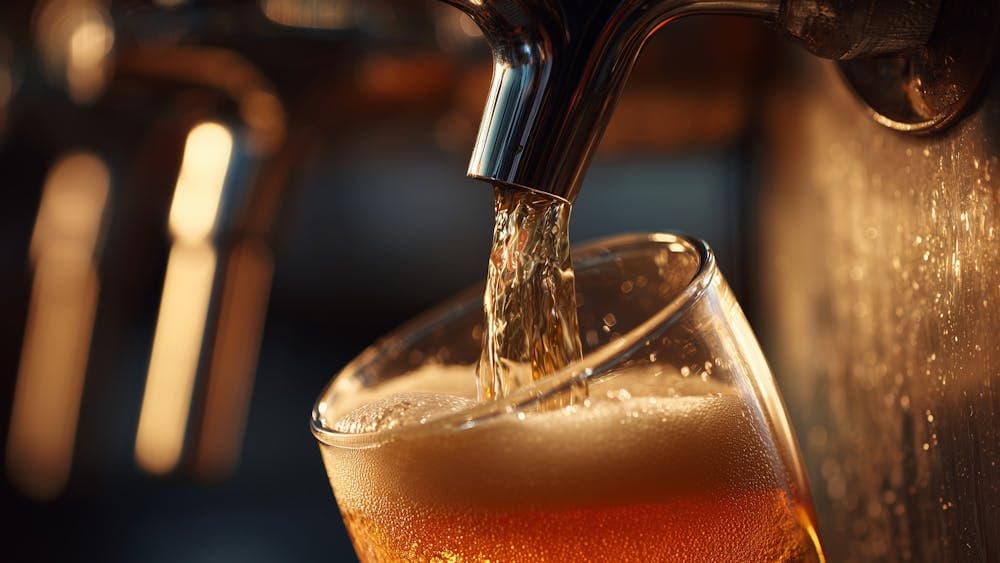 A beer being poured into a pot glass