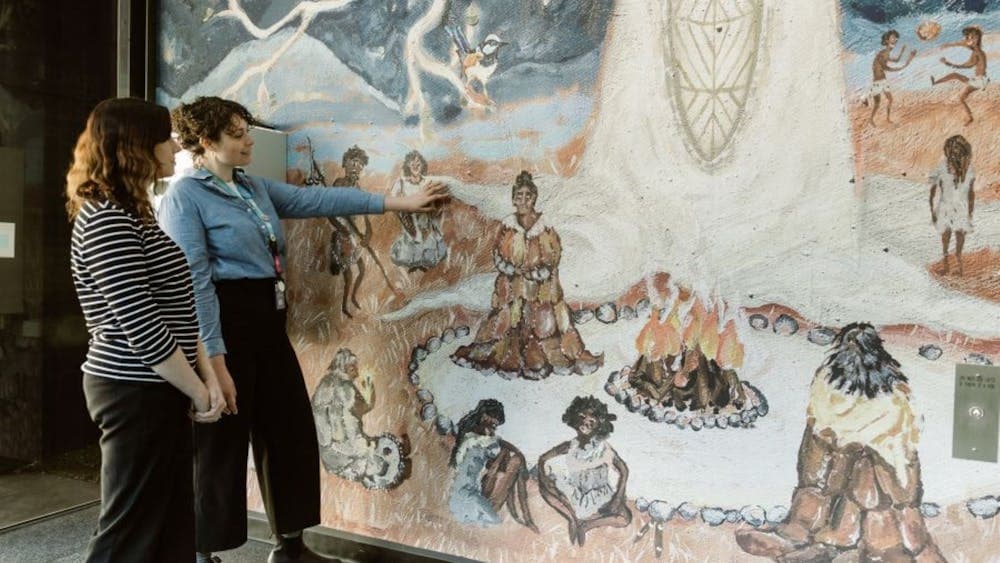 A visitor servicing staff member guiding a tour participant