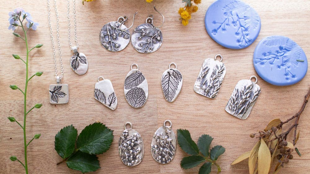 Pairs of metal clay earrings on a table