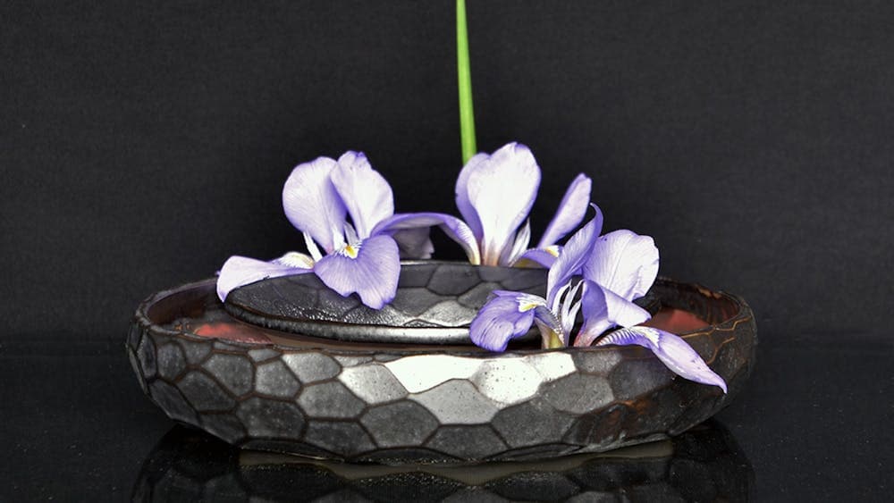 Silver pot with purple flowers