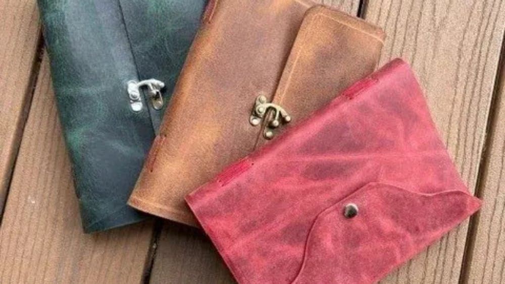 Three leather soft journal covers in red, tan and black