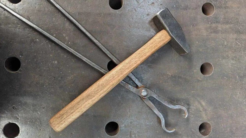 Hammer and tongs on metal surface