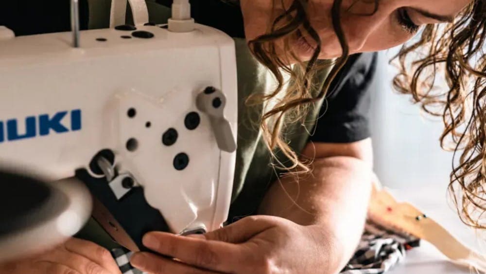 Woman sewing at sewing machine