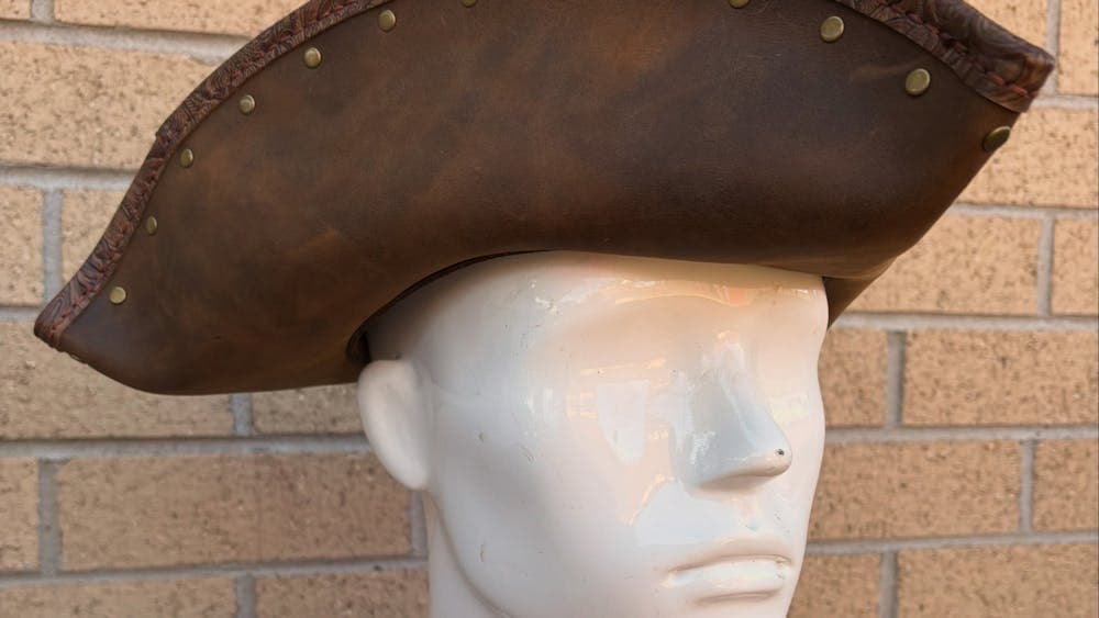 Dark tan leather tricorn pirate hat on mannequin head