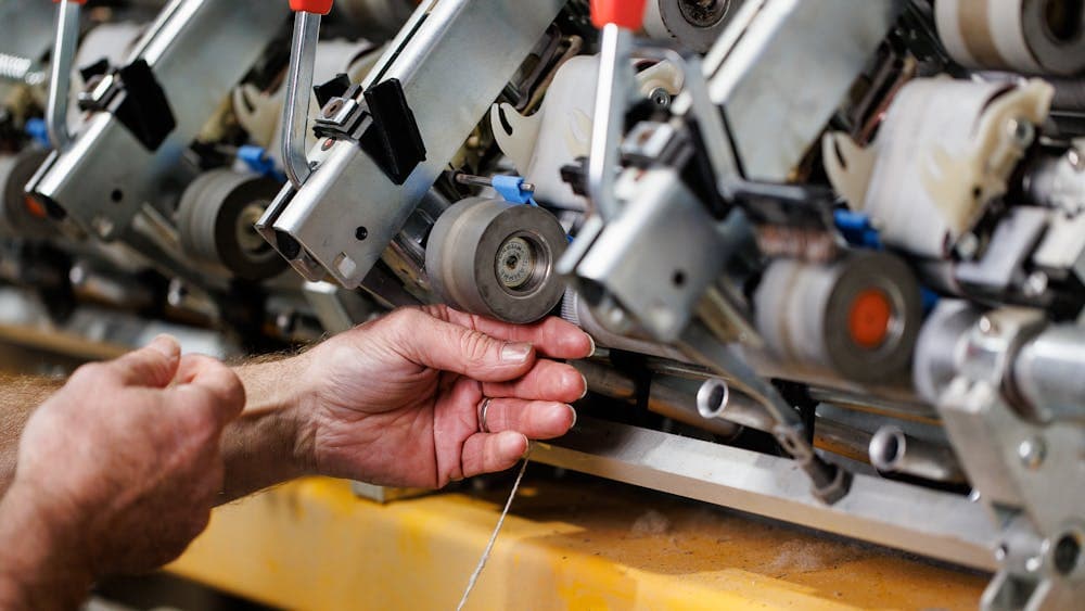 2 hands are setting up a spinner.