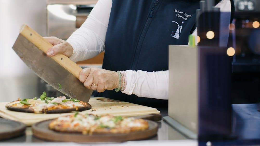 Tracey cutting pizza in the Food Van Clara