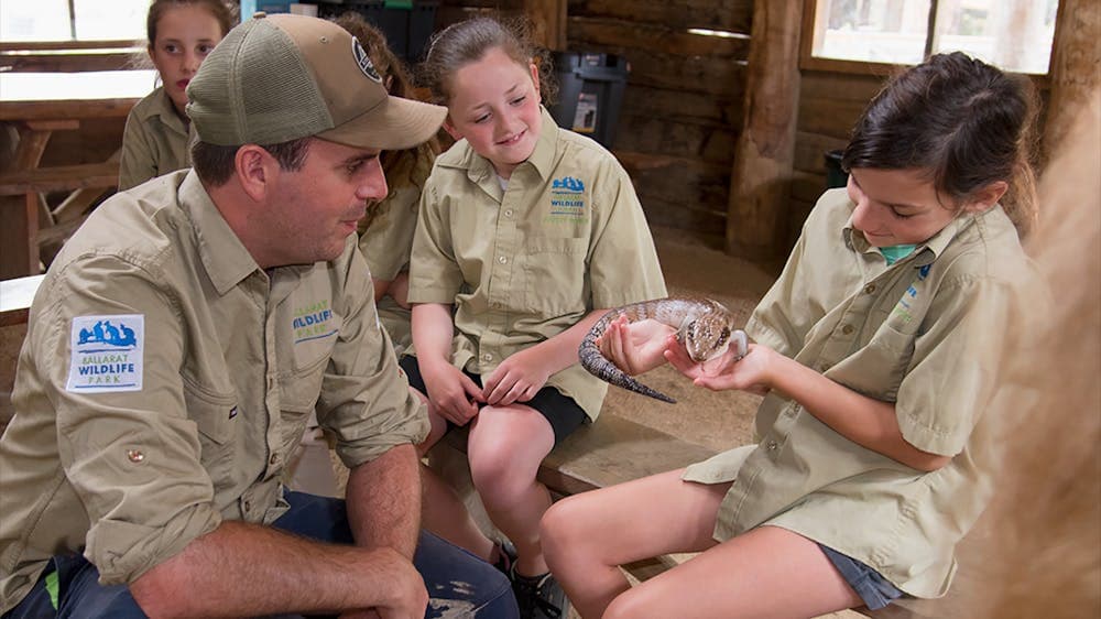 Zoo Keeper teaching children about a lizard