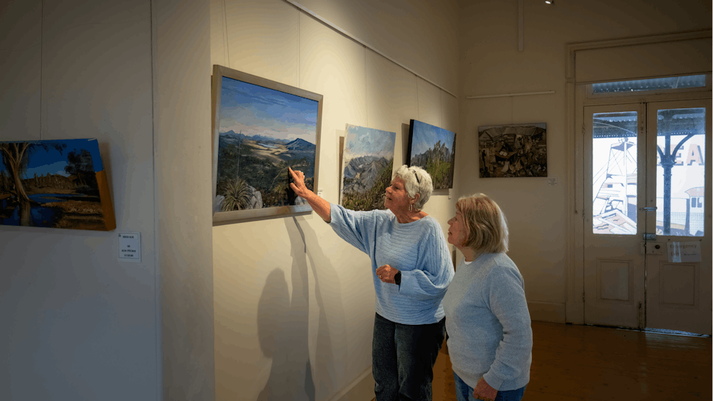Two women looking at art work