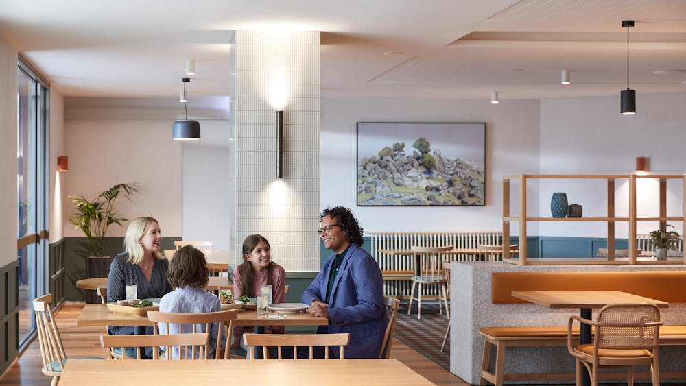 Family sitting down for meal in restaurant
