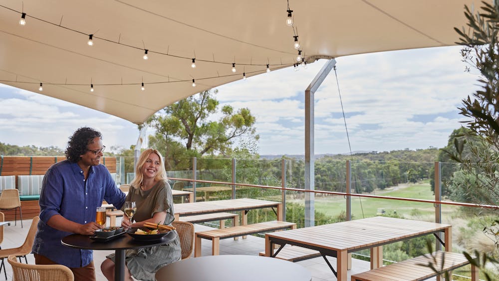 Couple talking at outdoor bar