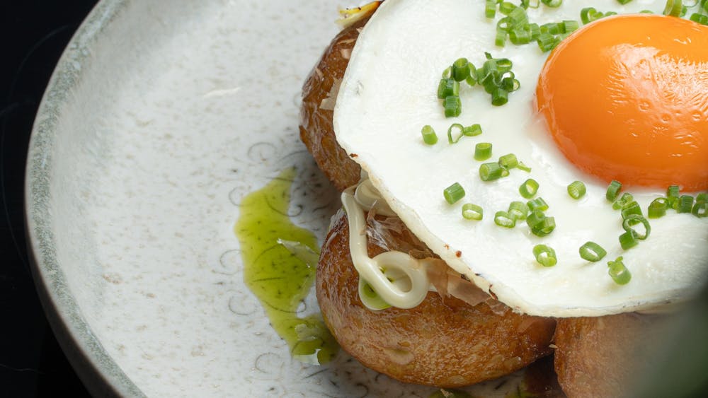 Crispy balls of Octopus Takoyaki topped with a sunny side up egg