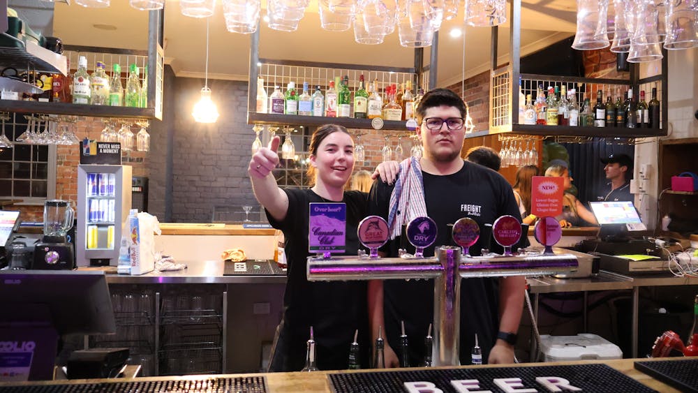 Bar staff standing behind the bar at Freight Bar.