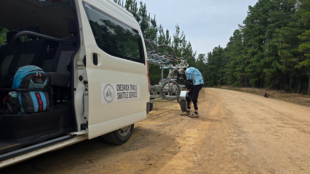 van with open door and person with a bike