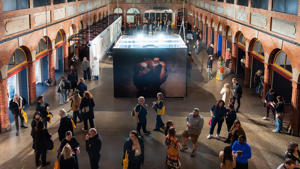 People in a photography exhibition inside a heritage building.