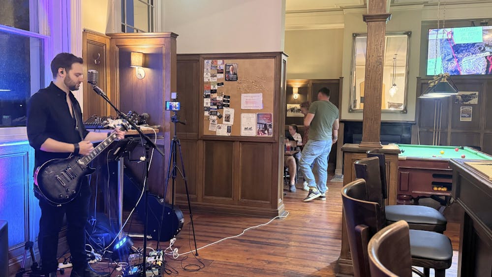 Musicians performing live music inside the Courthouse Hotel with guests enjoying the venue.