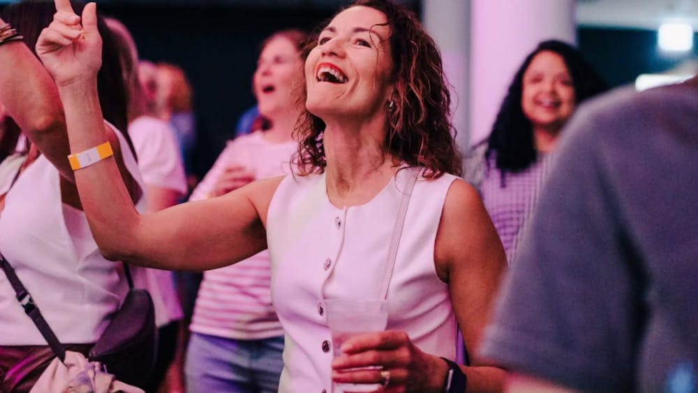 A woman having the time of her life and singing along