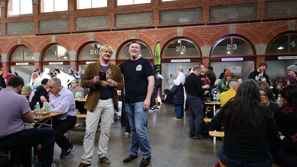Two attendees posing in the festival hall