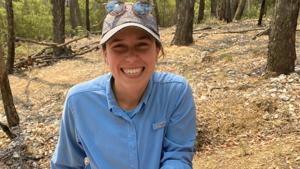 Smiling guest holding a small gold nugget found during a guided prospecting adventure.