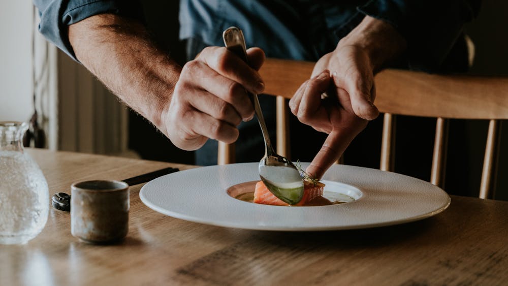 Head Chef Aaron Schembri Precisely Plating The Ora Salmon