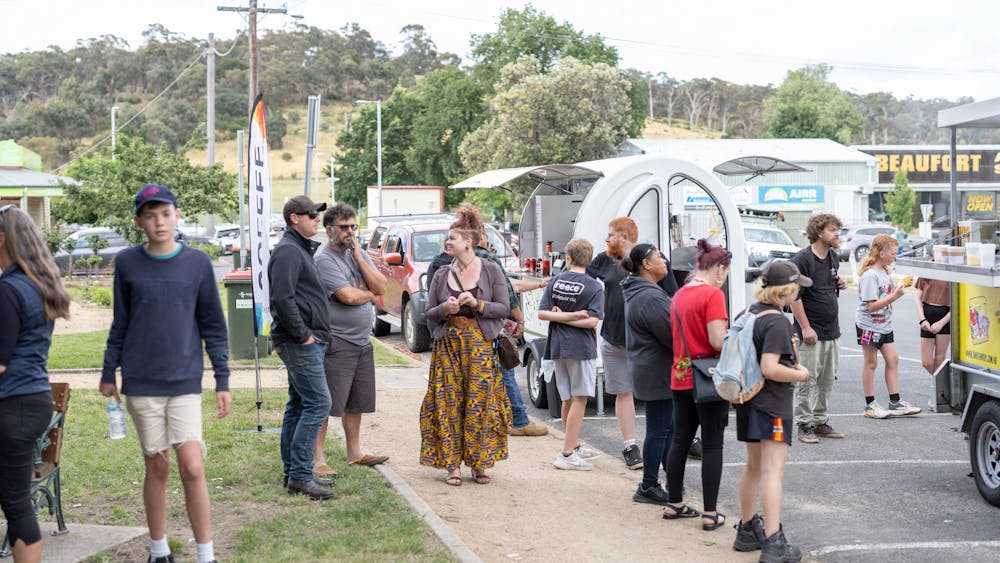 People gathered around the food trucks