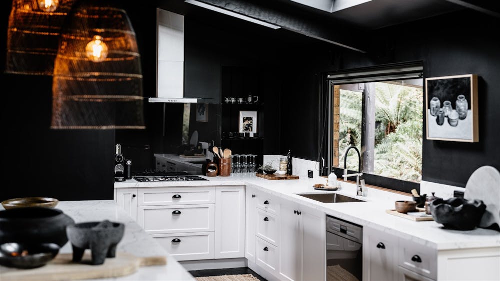 Jumoku Kitchen with black walls and white furnishings
