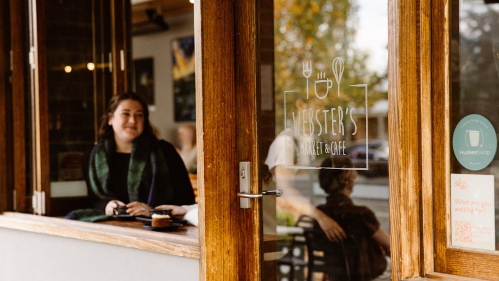 Customer enjoying coffee at the window inside Webster's Market and Cafe.