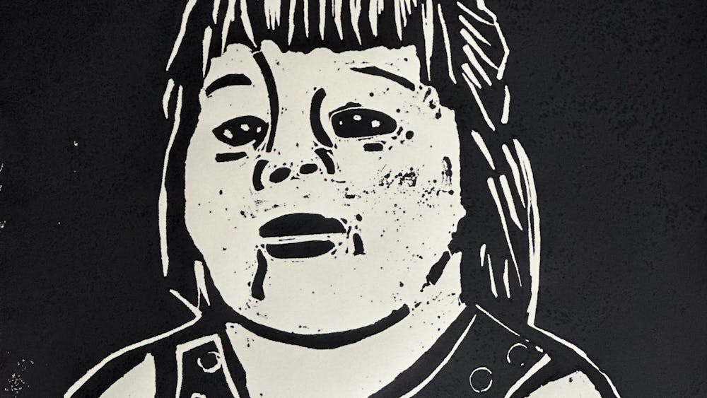 A black and white portrait in lino print of a woman with long hair and a black top.