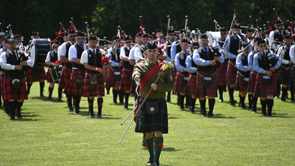 Drum Major marches at the head of 20 Massed Pipe Bands on field