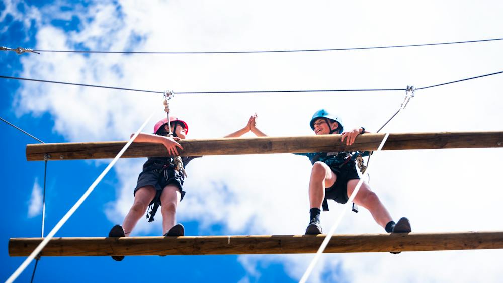 Two campers on giant ladder