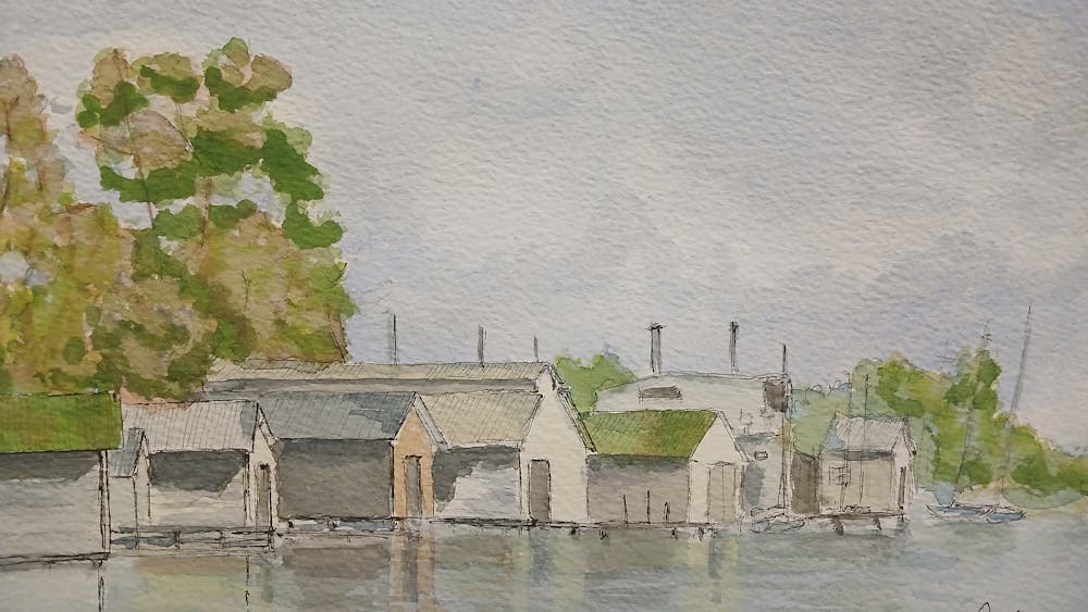 Tranquil scene of Lake Wendouree boatsheds on a calm day with reflections .