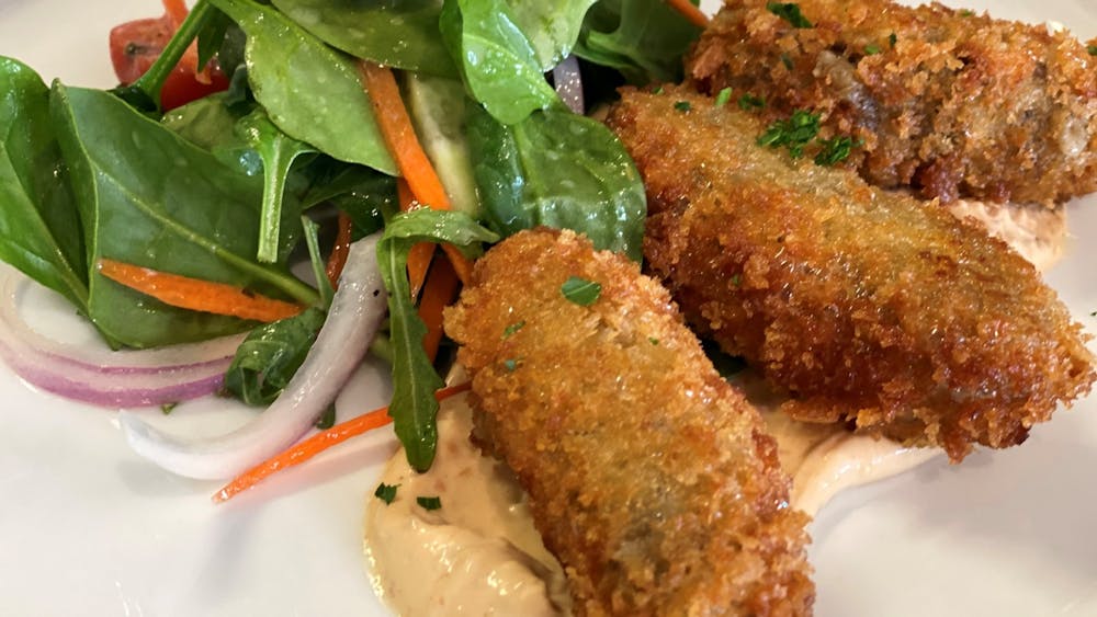 Mushroom croquettes plated at Bad Habits Café