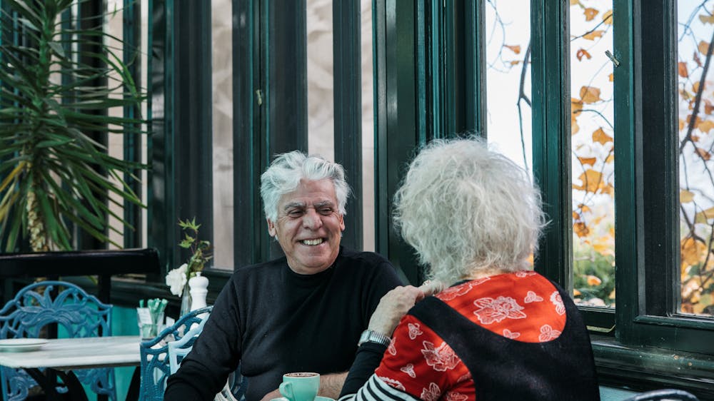 A couple sitting in the café enjoying a coffee